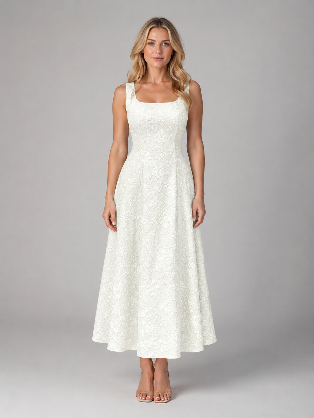 Woman wearing a white dress against a gray background