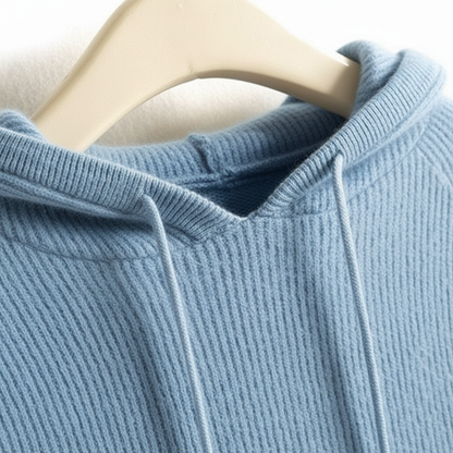 Light blue ribbed cashmere-mink blend hoodie with a soft texture and drawstring hood on a hanger.