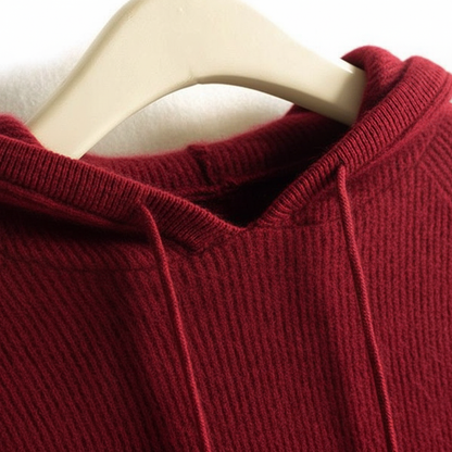 Deep red cashmere-mink blend hoodie featuring a soft ribbed texture and matching drawstring hood on a hanger.