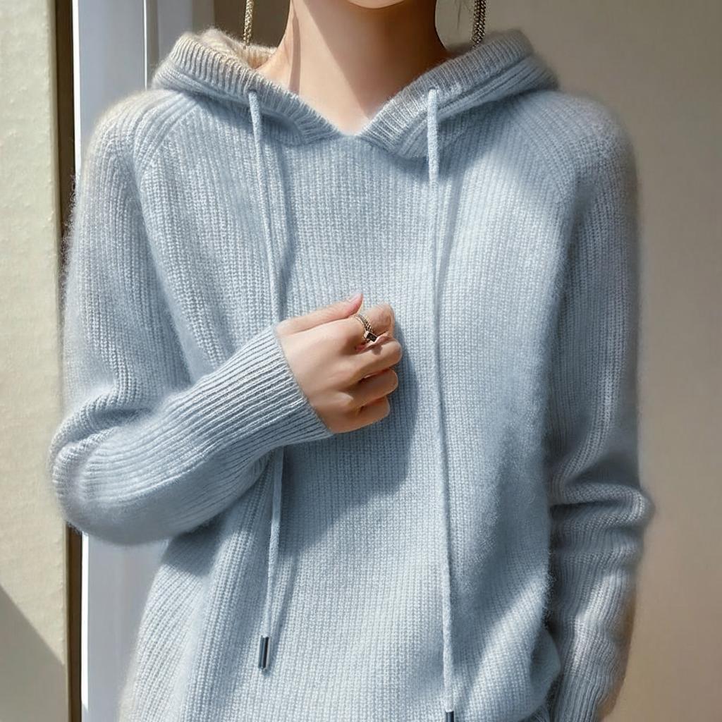 Light blue cashmere-mink blend hoodie with ribbed trim, long sleeves, and a soft draped silhouette.