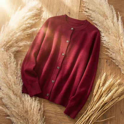 Deep red Merino wool cardigan with a classic button-front design, long sleeves, and a soft, delicate knit texture.