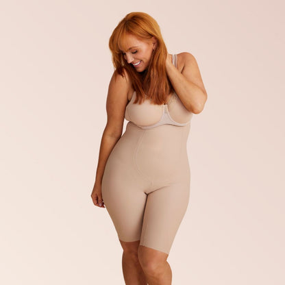 Beige high-waisted shapewear shorts with tall-length coverage and targeted compression panels for a smooth silhouette.